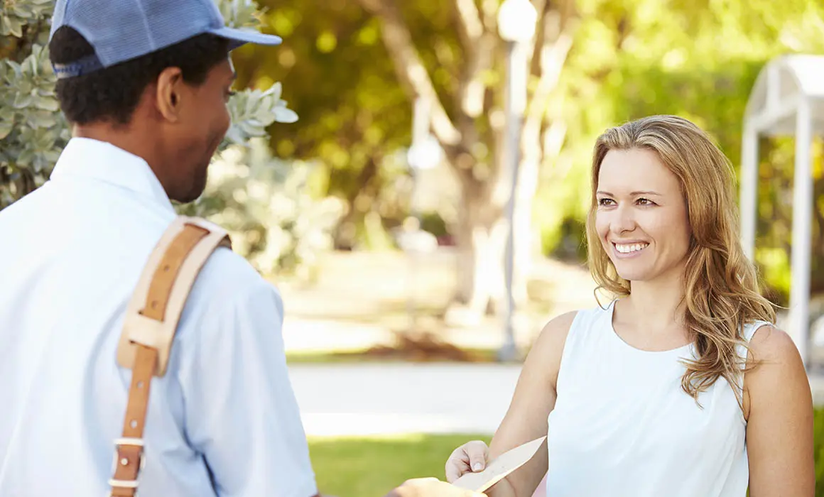 Mailman Delivering Letters To Woman