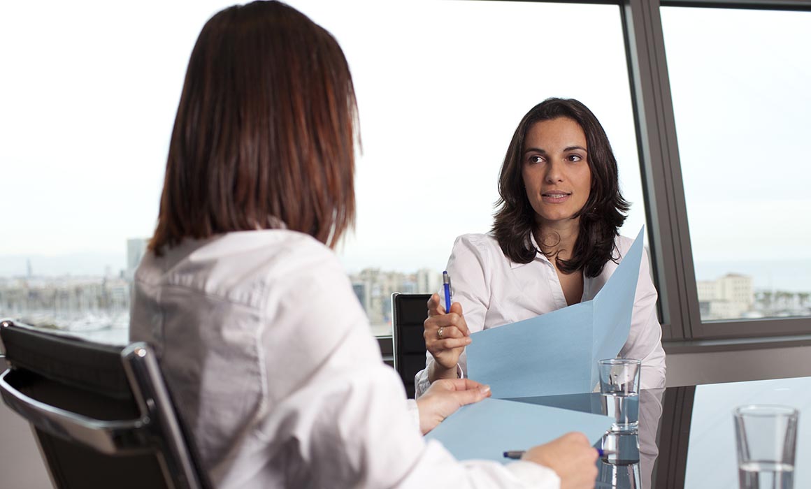 Two of Intelligent Evolution clients talking in their office