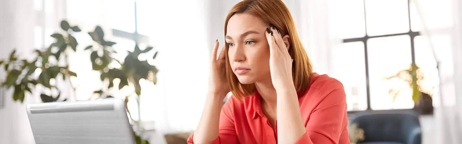 Stressed woman with laptop working at office waiting for IT support from Intelligent Evolution